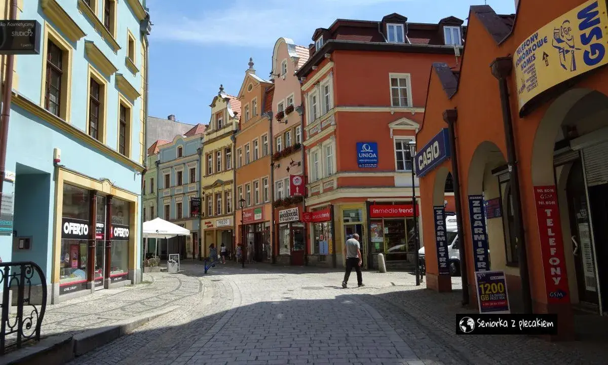 Kolorowe kamienice i brukowana uliczka tworzą urokliwy zakątek, idealny do odkrywania atrakcji Jeleniej Góry.